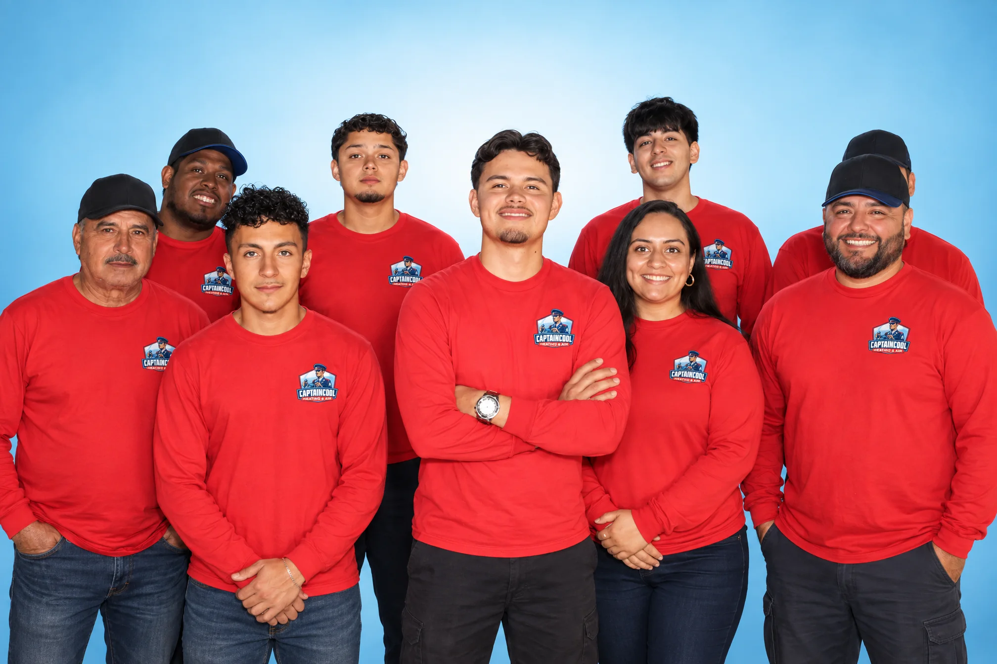 The Captain Cool Heating & Air team in red company shirts, posed together for a studio portrait