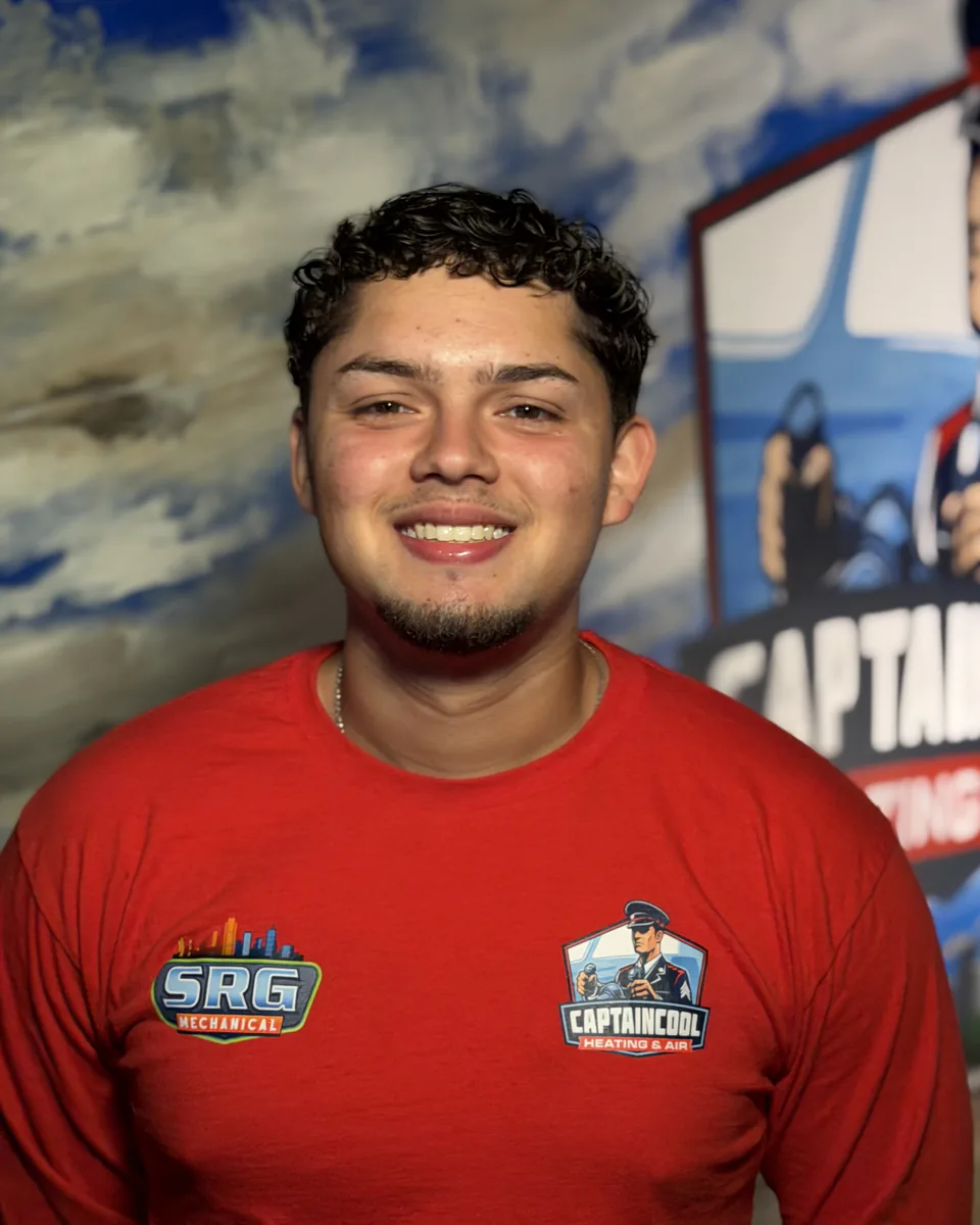 Smiling Captain Cool Heating & Air team member in a red company shirt