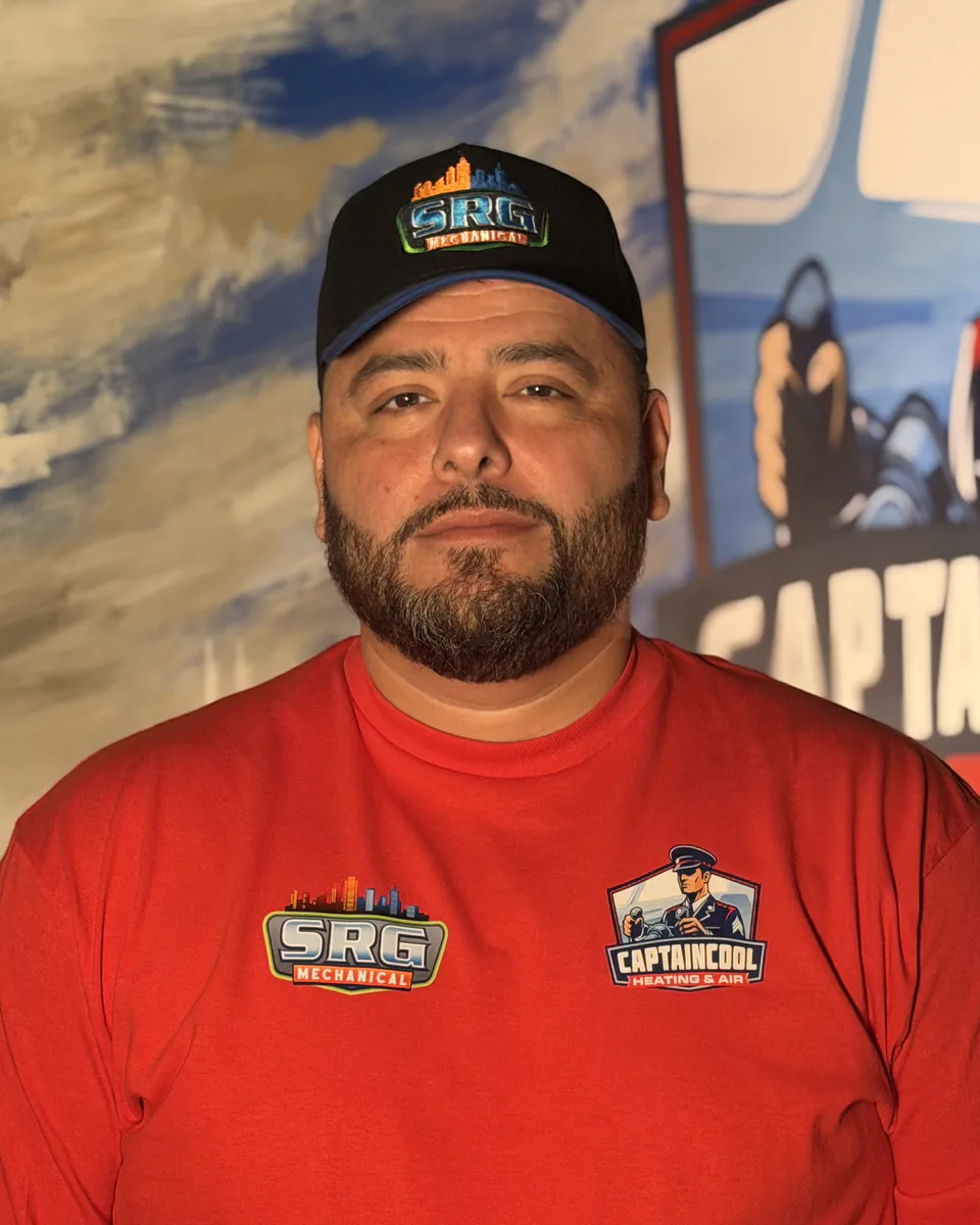 Captain Cool Heating & Air team member in a cap and red company shirt
