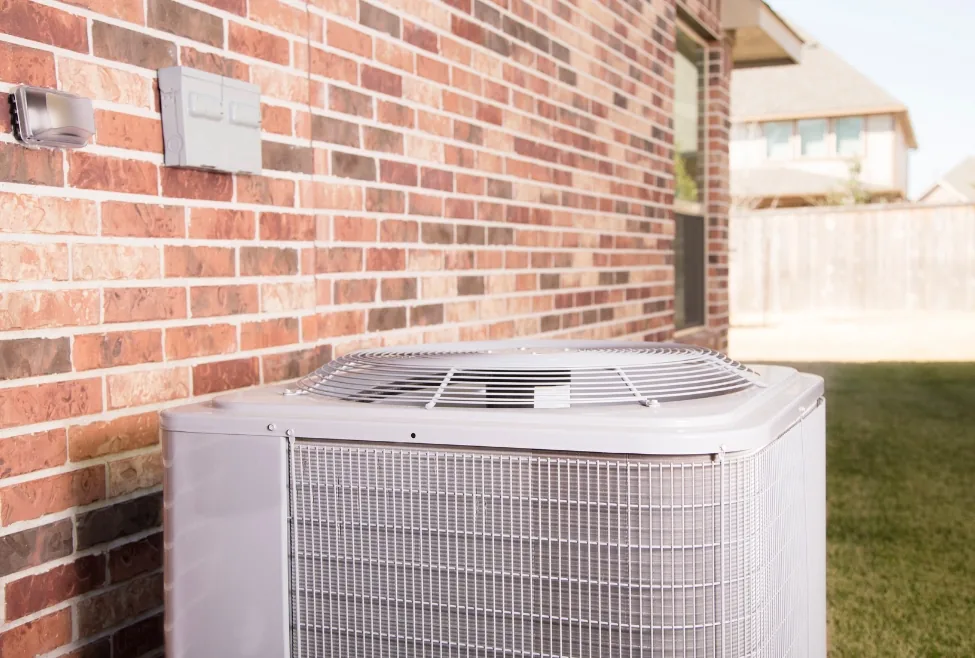 Commercial or residential HVAC system undergoing emergency HVAC repair, technician inspecting air conditioner and furnac